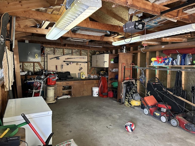 garage featuring a garage door opener and a workshop area