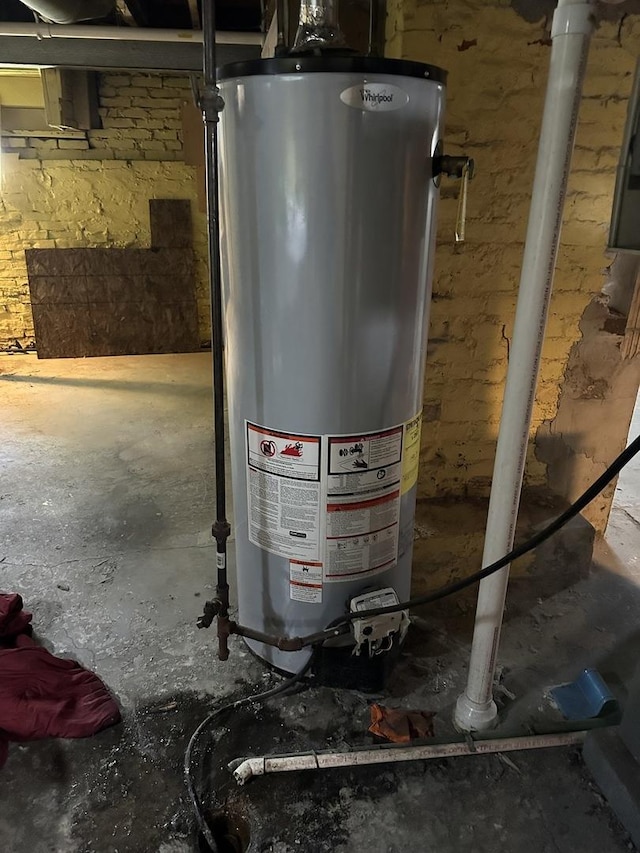 utility room featuring water heater