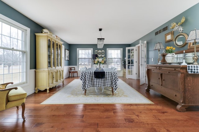 dining space featuring visible vents and wood finished floors