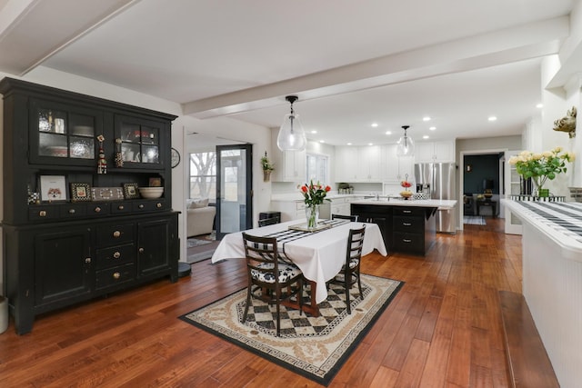 dining area with recessed lighting, beam ceiling, and hardwood / wood-style flooring