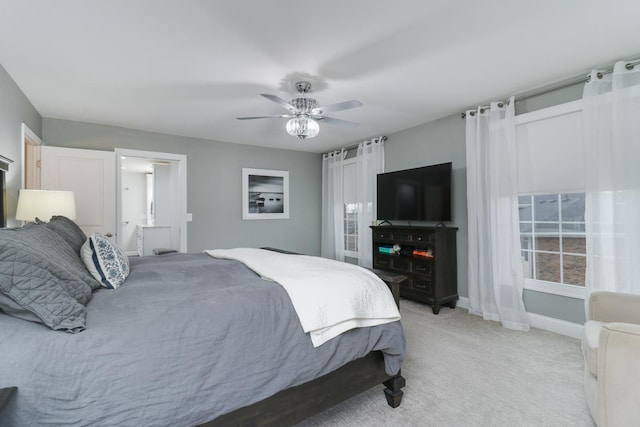 bedroom with light carpet, ceiling fan, and baseboards