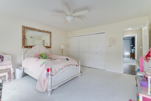 carpeted bedroom with a ceiling fan, a closet, and baseboards