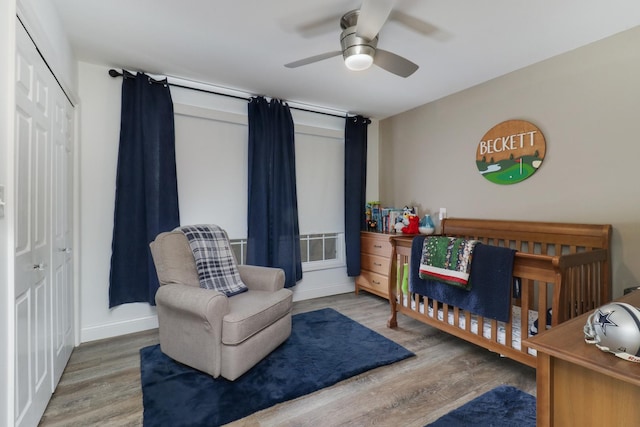 bedroom featuring a closet, ceiling fan, baseboards, and wood finished floors