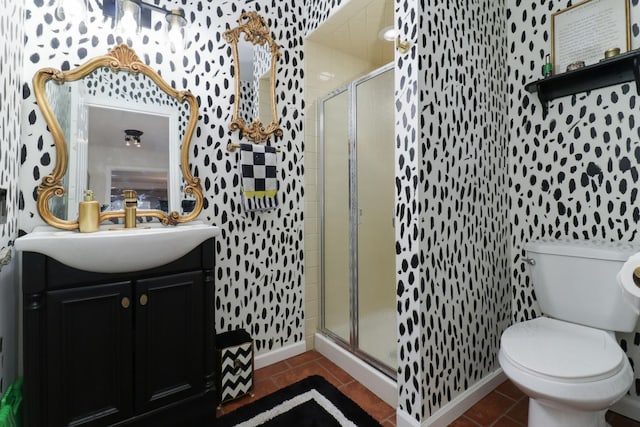 full bathroom featuring tile patterned flooring, toilet, vanity, baseboards, and a shower stall