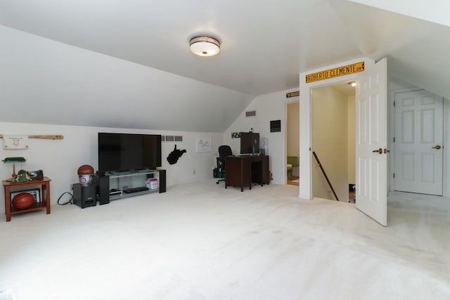 interior space with vaulted ceiling, carpet, and visible vents