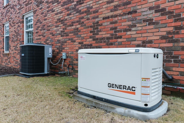 details with a power unit, cooling unit, and brick siding