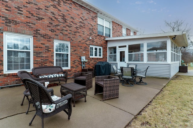 view of patio featuring an outdoor hangout area, a grill, and a sunroom