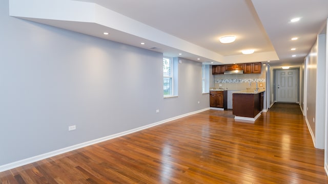 interior space featuring wet bar, dark wood-style flooring, baseboards, and recessed lighting