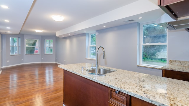 kitchen featuring light stone counters, recessed lighting, a sink, visible vents, and dark wood-style floors