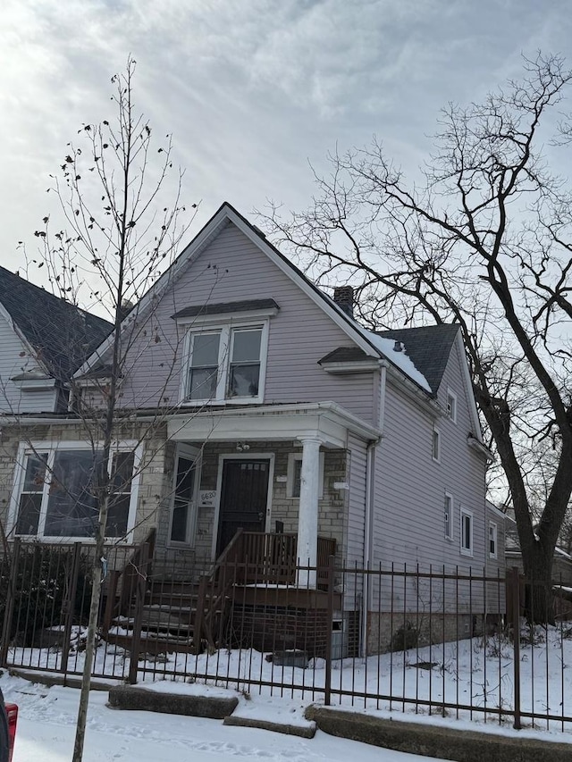 view of front of property featuring a chimney and fence