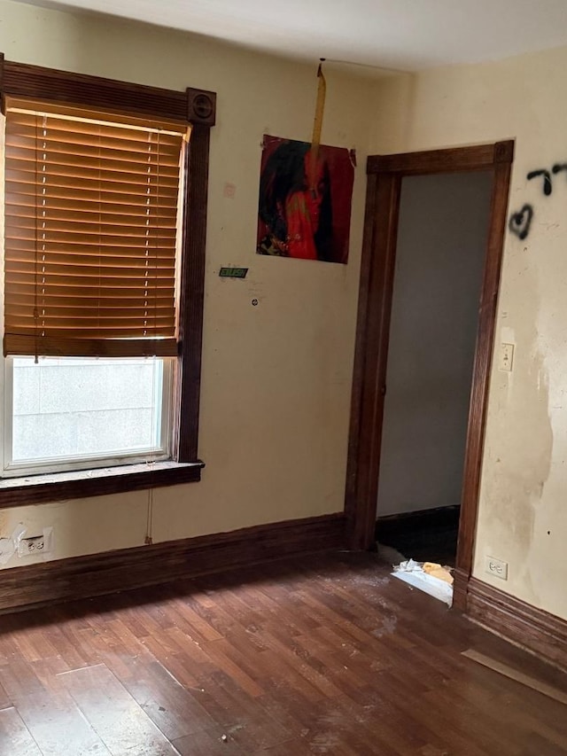 interior space with baseboards and wood finished floors