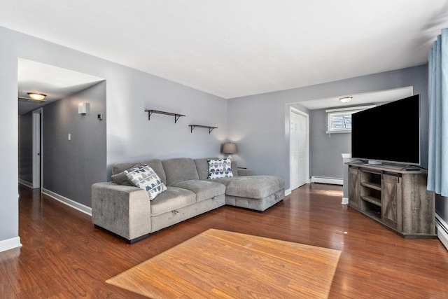 living area with baseboards, baseboard heating, and wood finished floors