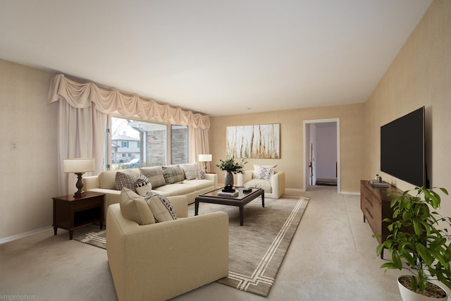 living area with light colored carpet and baseboards