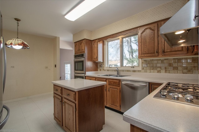 kitchen featuring wallpapered walls, custom exhaust hood, appliances with stainless steel finishes, and a sink