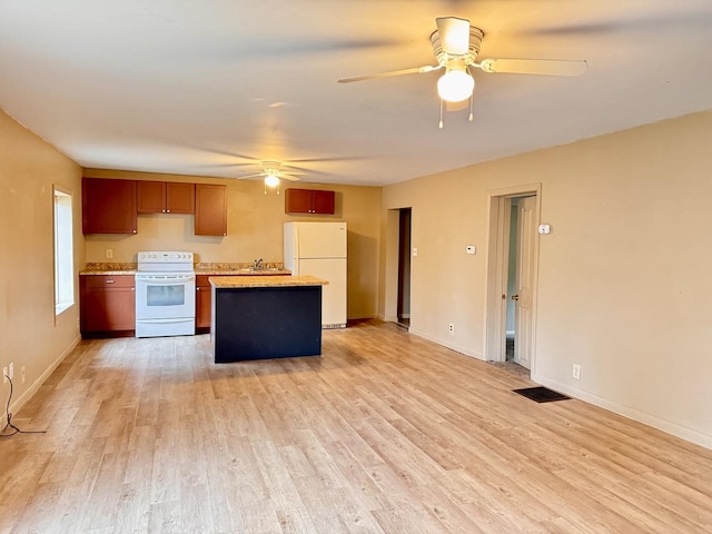 kitchen featuring ceiling fan, white appliances, baseboards, light countertops, and light wood finished floors