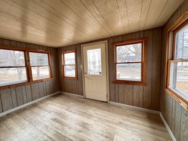 unfurnished sunroom featuring wood ceiling