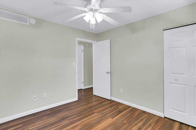 1001 E Sunnycrest Dr, Urbana, IL 61801 - unfurnished bedroom with baseboards, wood finished floors, a ceiling fan, and a closet