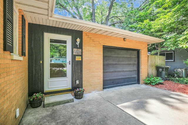1001 E Sunnycrest Dr, Urbana, IL 61801 - doorway to property with brick siding and a garage