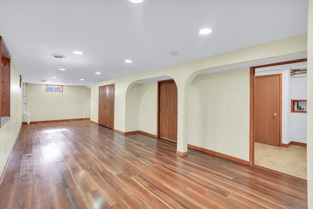 1001 E Sunnycrest Dr, Urbana, IL 61801 - unfurnished room with wood finished floors, recessed lighting, arched walkways, and baseboards