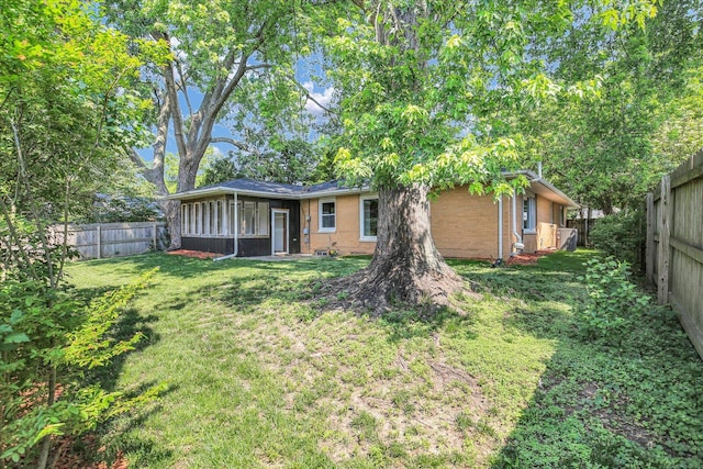 1001 E Sunnycrest Dr, Urbana, IL 61801 - back of property featuring brick siding and a sunroom