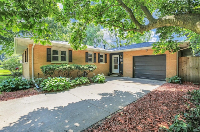 1001 E Sunnycrest Dr, Urbana, IL 61801 - ranch-style house with brick siding, an attached garage, and concrete driveway