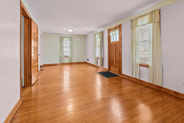 entryway featuring light wood-style flooring, baseboards, and wallpapered walls