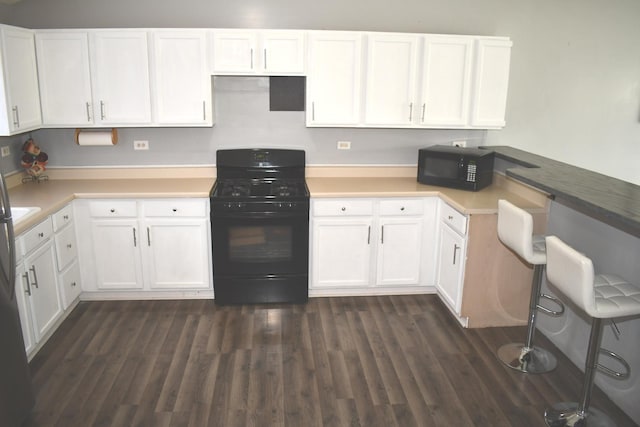 1080 Redondo Dr, Romeoville, IL 60446 - kitchen with black appliances, white cabinets, and dark wood finished floors