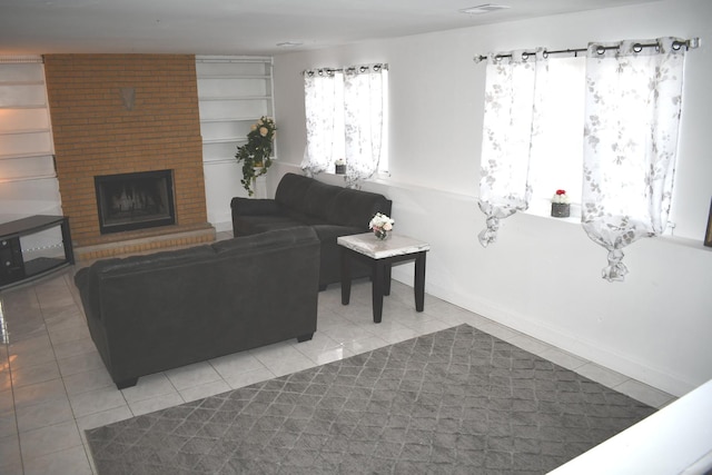1080 Redondo Dr, Romeoville, IL 60446 - living room featuring a brick fireplace and light tile patterned floors