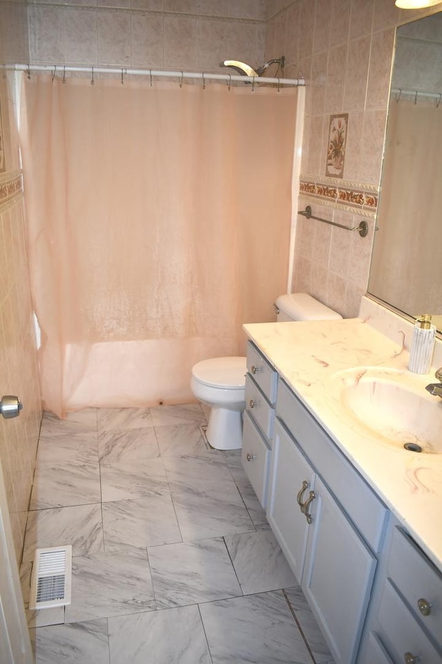 1080 Redondo Dr, Romeoville, IL 60446 - full bathroom with vanity, shower / tub combo, tile walls, and marble finish flooring