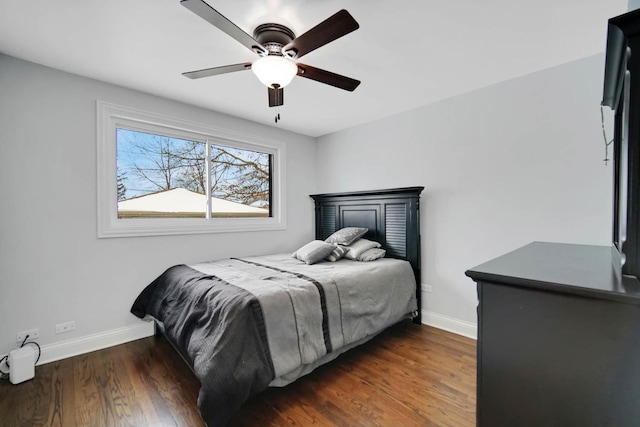 bedroom featuring ceiling fan, baseboards, and dark wood-type flooring