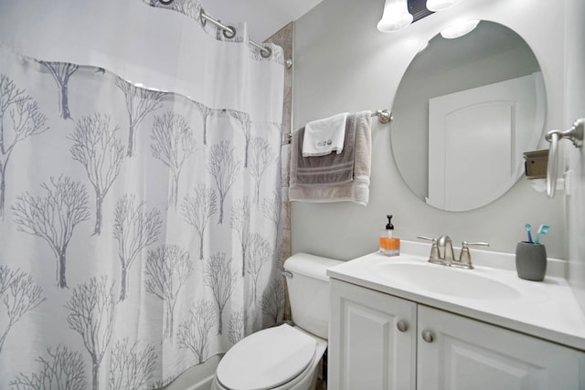 bathroom featuring toilet, vanity, and a shower with shower curtain