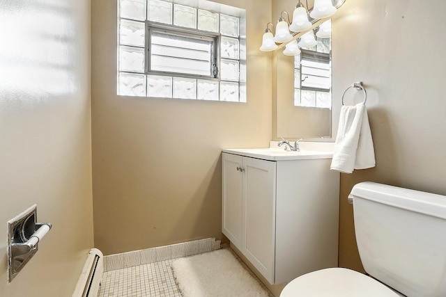 bathroom featuring toilet, a baseboard heating unit, a chandelier, and vanity