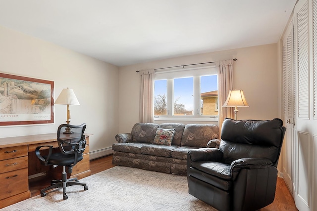 office with baseboard heating and wood finished floors