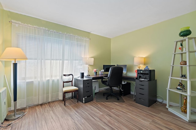 home office featuring wood finished floors and baseboards