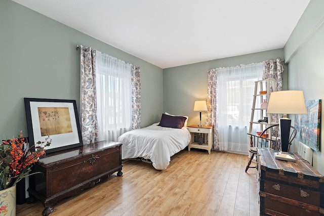 bedroom featuring multiple windows and hardwood / wood-style floors