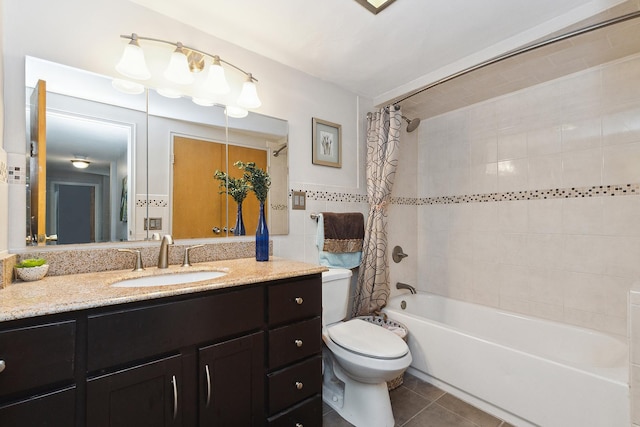 full bathroom with toilet, vanity, tile walls, tile patterned floors, and shower / bath combo with shower curtain