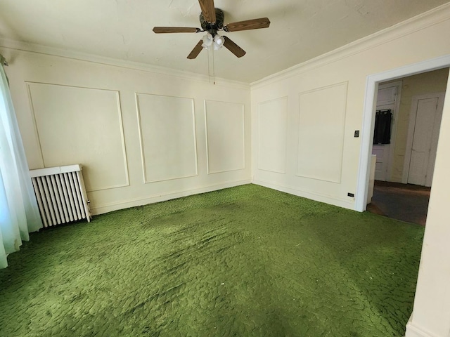 spare room with crown molding, a decorative wall, and a ceiling fan