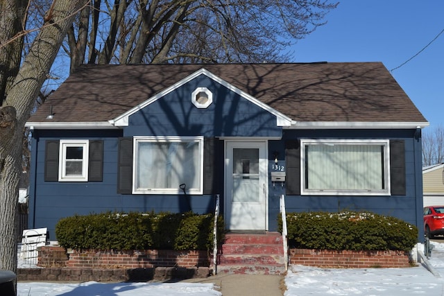 bungalow-style home featuring entry steps and a shingled roof