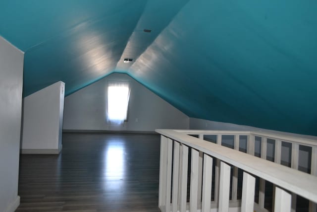 bonus room with vaulted ceiling, baseboards, and dark wood finished floors