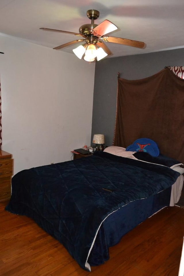 bedroom with ceiling fan and wood finished floors