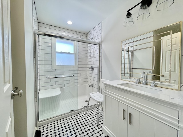 bathroom featuring a shower stall and vanity