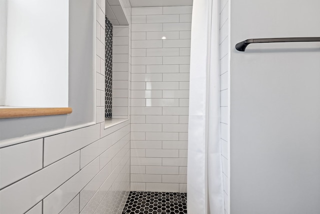 bathroom with tiled shower