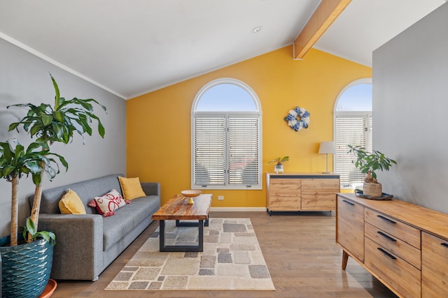 living room with baseboards, wood finished floors, and vaulted ceiling with beams