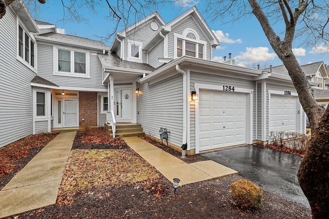 view of front facade featuring brick siding and driveway