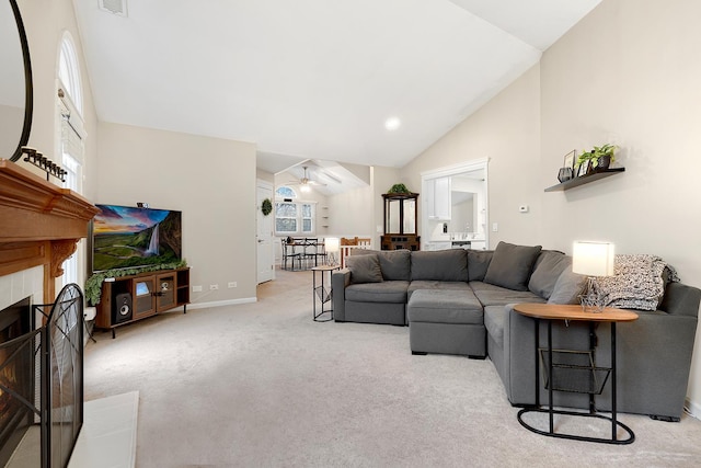 living area featuring high vaulted ceiling, a tile fireplace, carpet floors, a ceiling fan, and baseboards