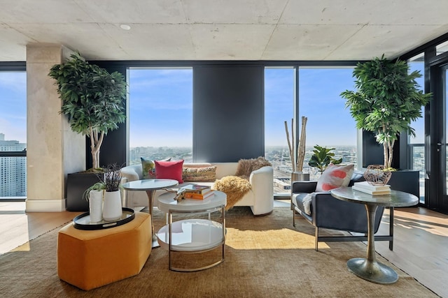 interior space with a wall of windows and wood finished floors