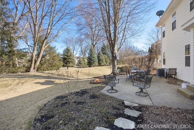 view of yard with central AC unit, a fire pit, and a patio