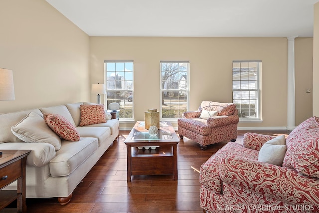 living room with baseboards, ornate columns, and dark wood-style flooring