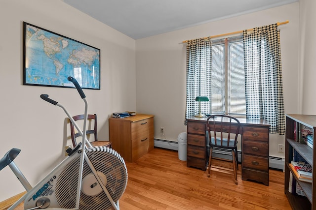 home office with a baseboard radiator and light wood-style flooring