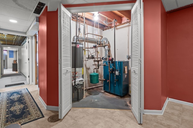 utility room featuring water heater and a heating unit